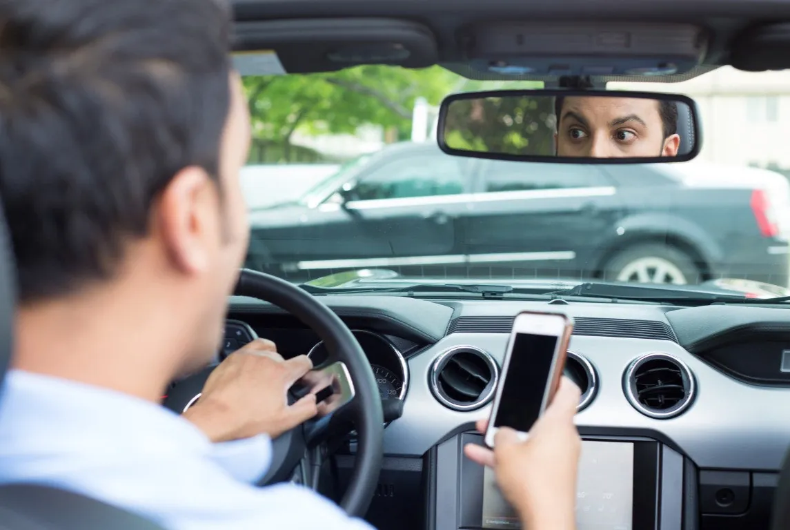 man distracted on cell phone while driving